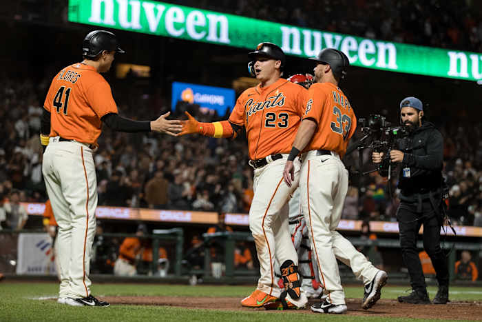 SF Giants outfielder Joc Pederson, infielder Wilmer Flores, and catcher Andrew Knapp celebrate after Pederson's three-run homer.